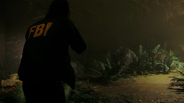 Saga pointing a gun at a wolf in Alan Wake 2.