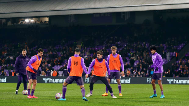 Football Manager 2024 promo shot with players practicing on the field.